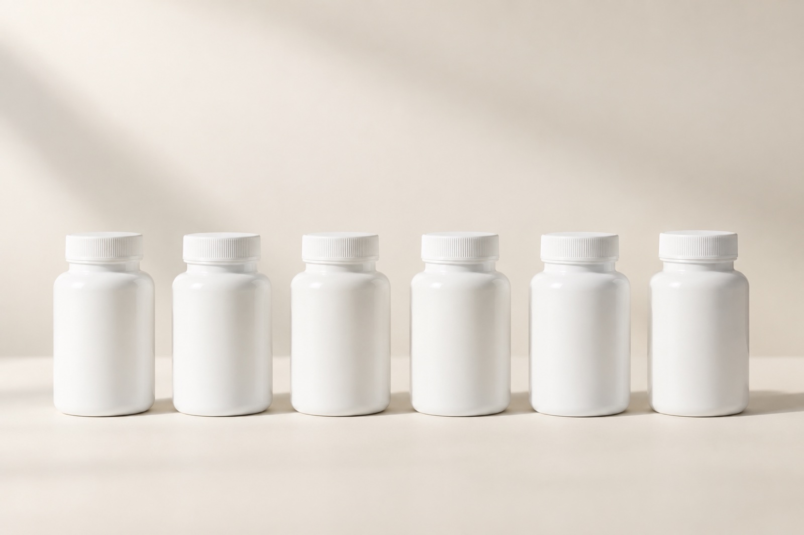 A row of unlabeled supplement bottles